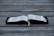 An open book displayed on a wooden surface, with visible tabs and a ribbon marker. The pages contain text in a neatly printed format.
