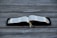 An open book displayed on a wooden surface, with visible tabs and a ribbon marker. The pages contain text in a neatly printed format.