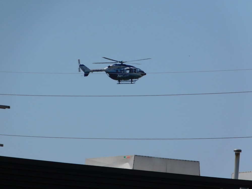 white and black helicopter in flight