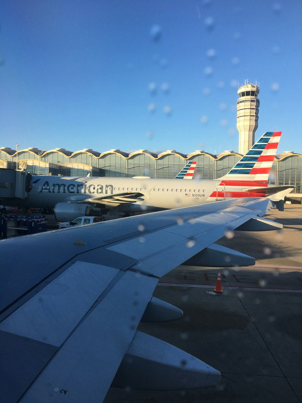 white, blue, and red American Airlines landing