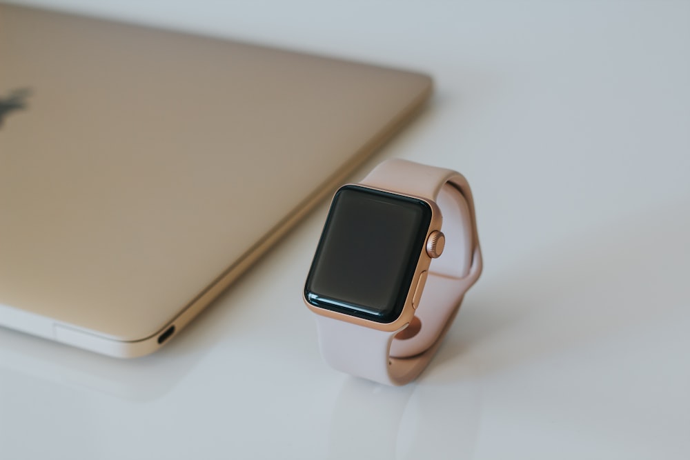 gold Apple Watch with white Sport Band