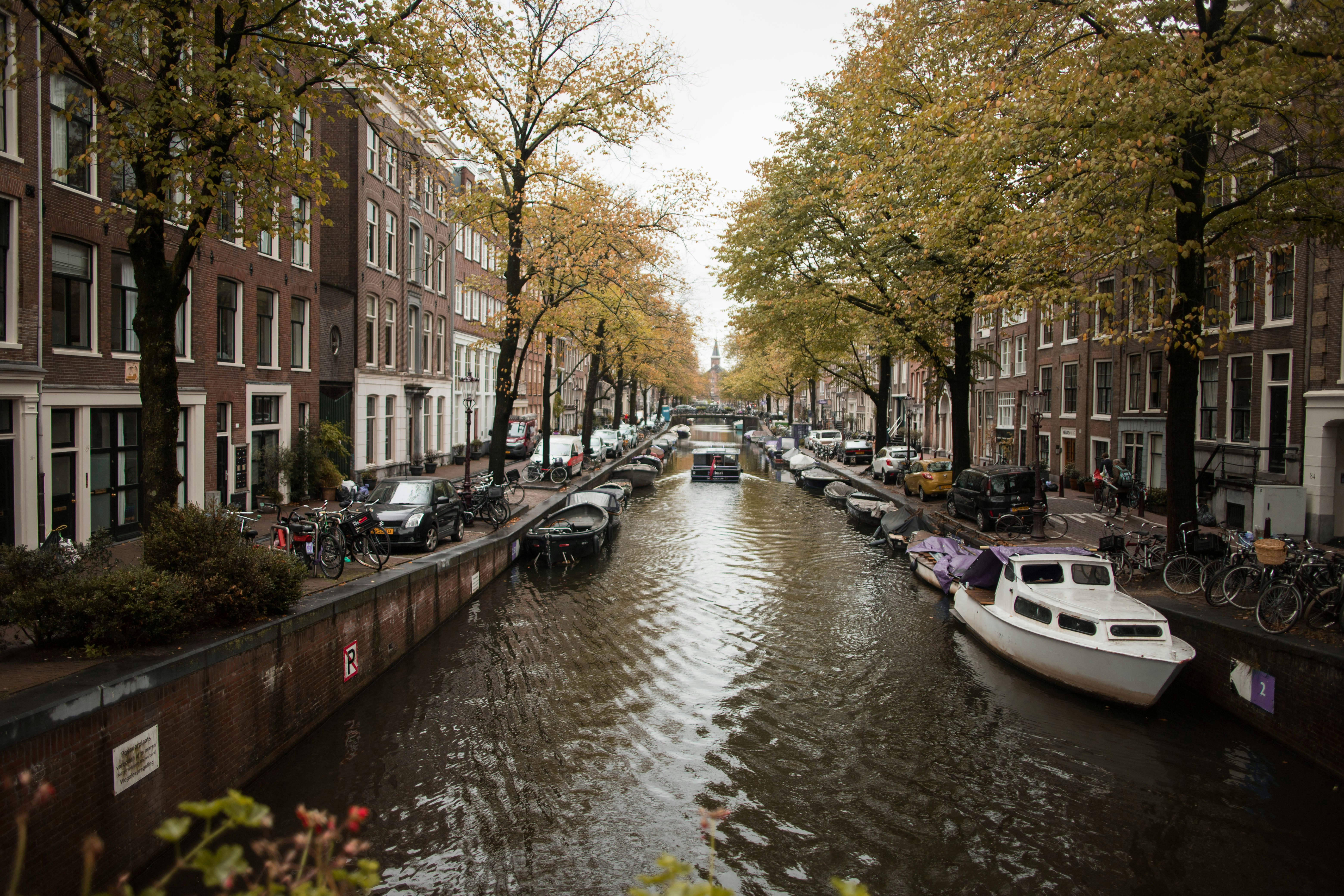 canal with boats between buildings, 