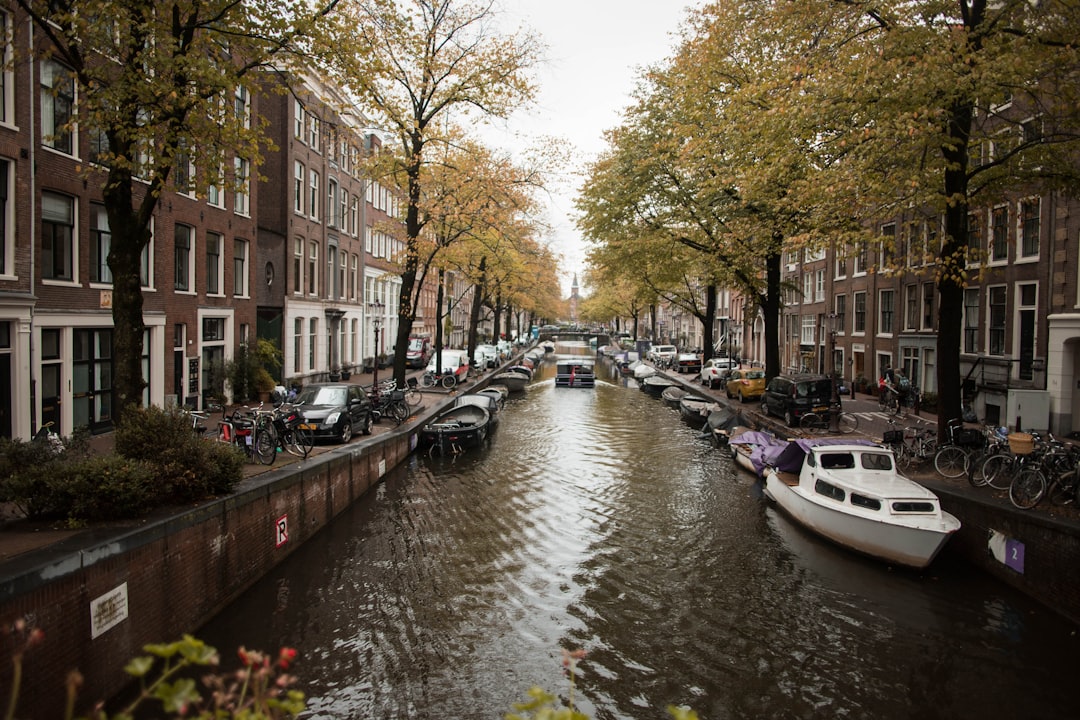 canal with boats between buildings,