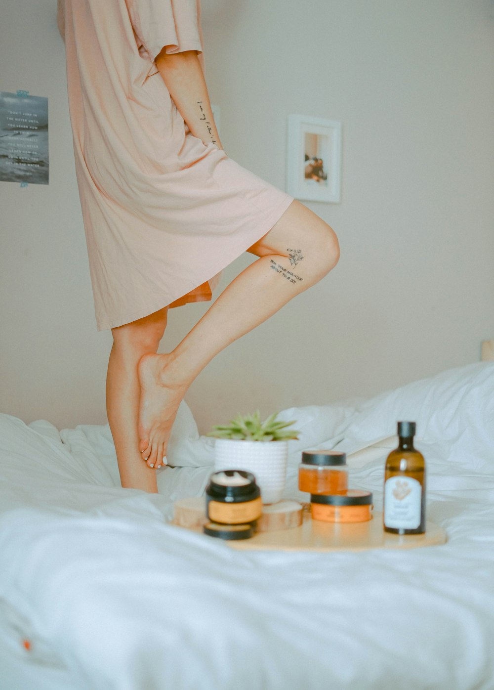 woman standing on bed