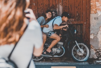 man and woman riding on motorcycle
