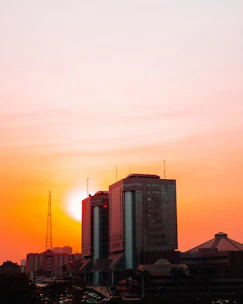 High-rise commercial building in Bangalore skyline at sunset.