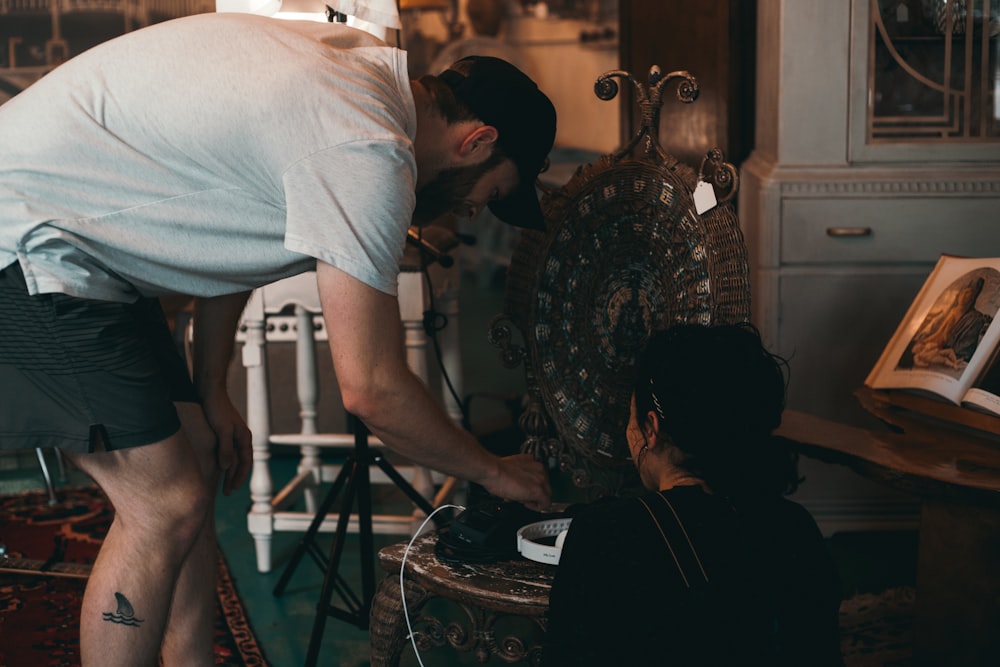 man in black cap, white t-shirt, and black shorts near woman