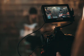 person captures woman playing guitar from the camera