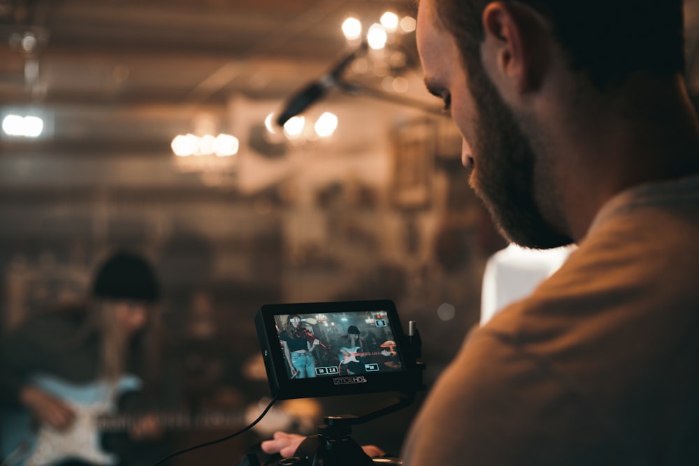 man holding black video camera