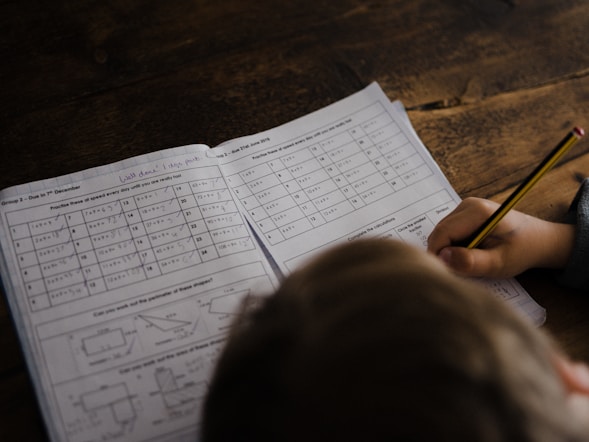Child engaged with a math worksheet, symbolizing academic practice challenges in the context 