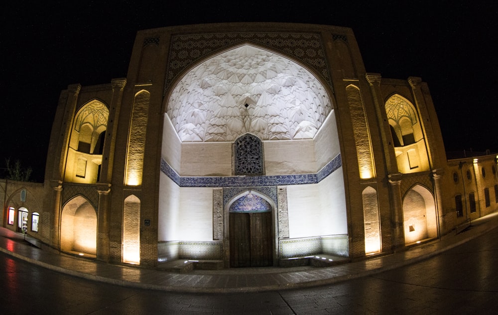 white building during nighttime with lights close-up photography