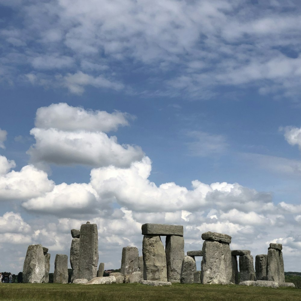 grey rock formation under white clouds