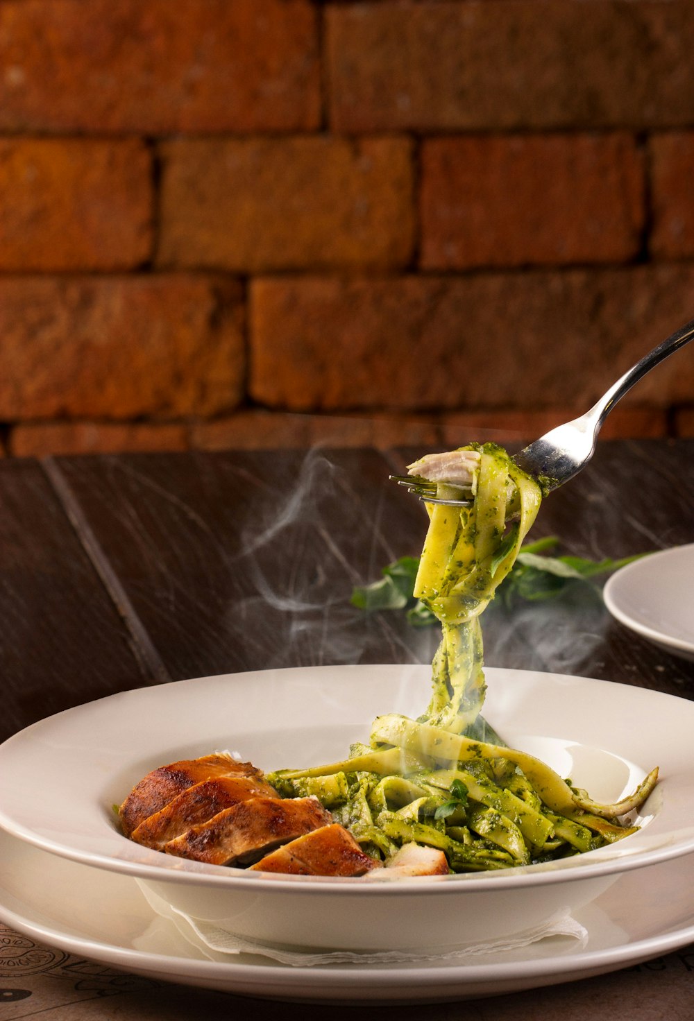 green pasta on white plate