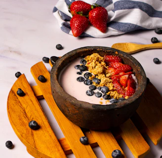 strawberries and black berries in brown bowl