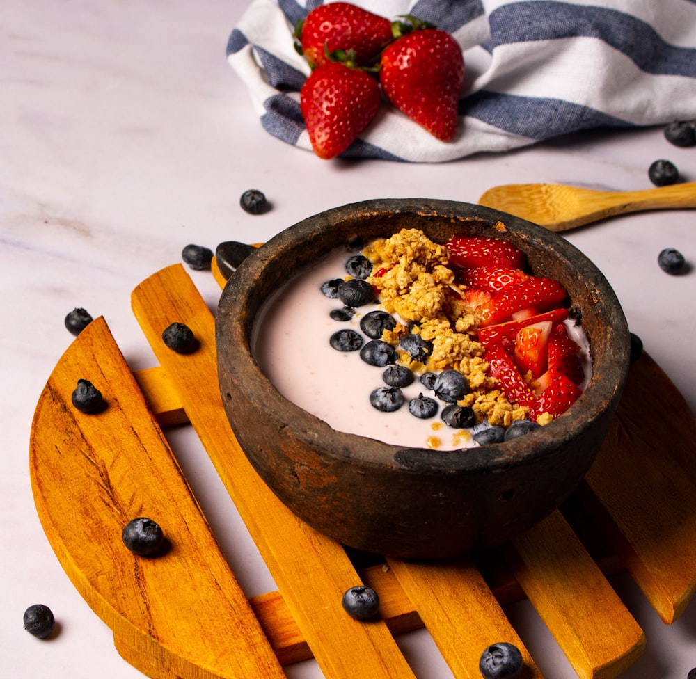 strawberries and black berries in brown bowl