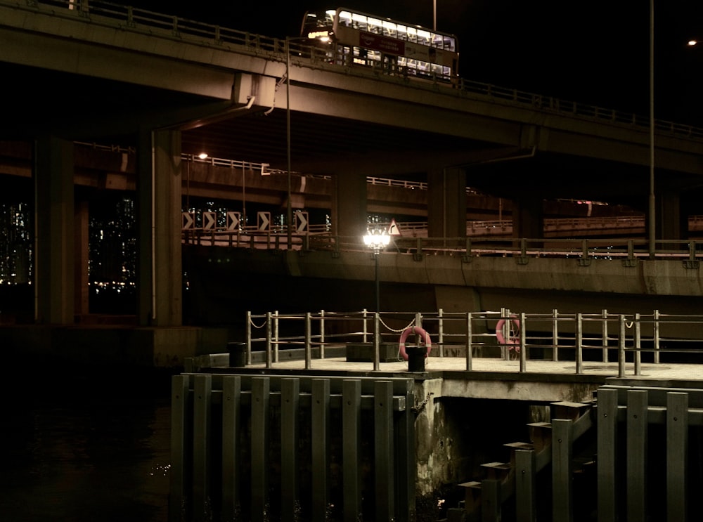 a person standing on a bridge over a body of water