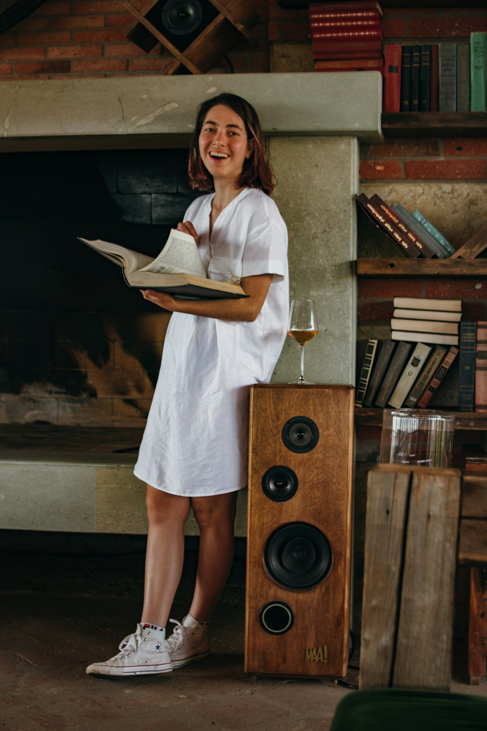 laughing woman standing and holding open book