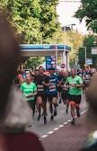 Group of runners wearing colorful gear racing along an urban street in Pará.