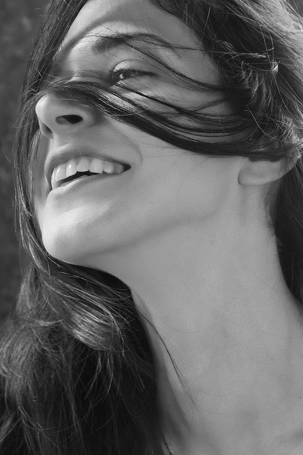 smiling woman grayscale photo