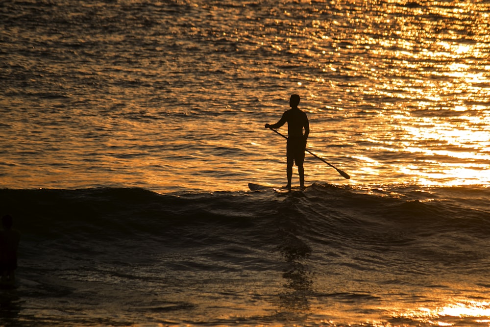 man in paddle board in ocean