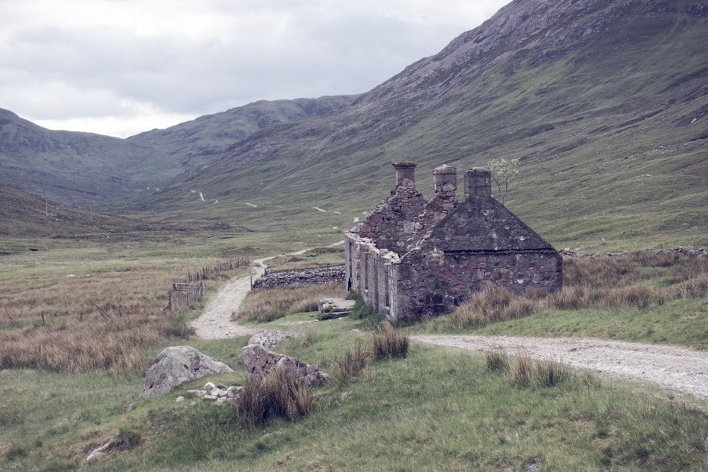 brown and grey stone house near hills