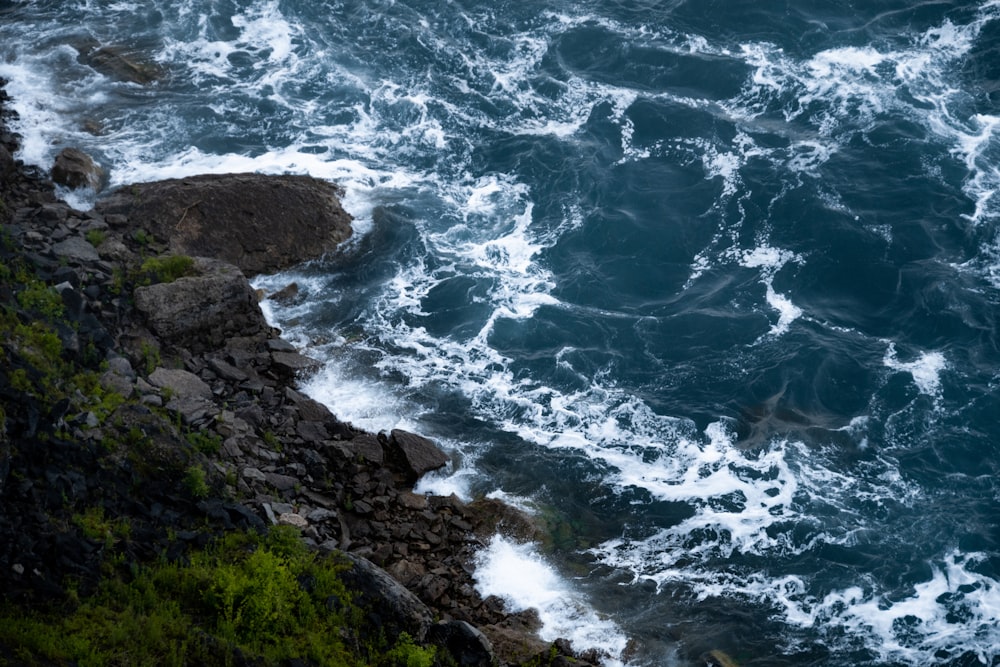 cliff near body of water during daytime