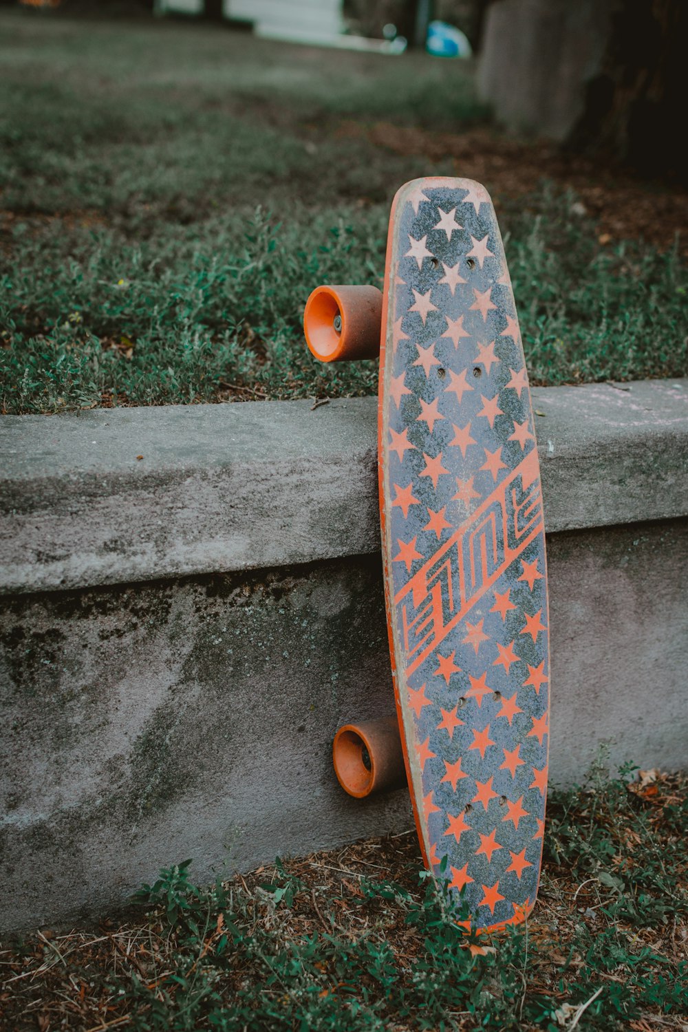 側溝にオレンジと黒のスケートボード