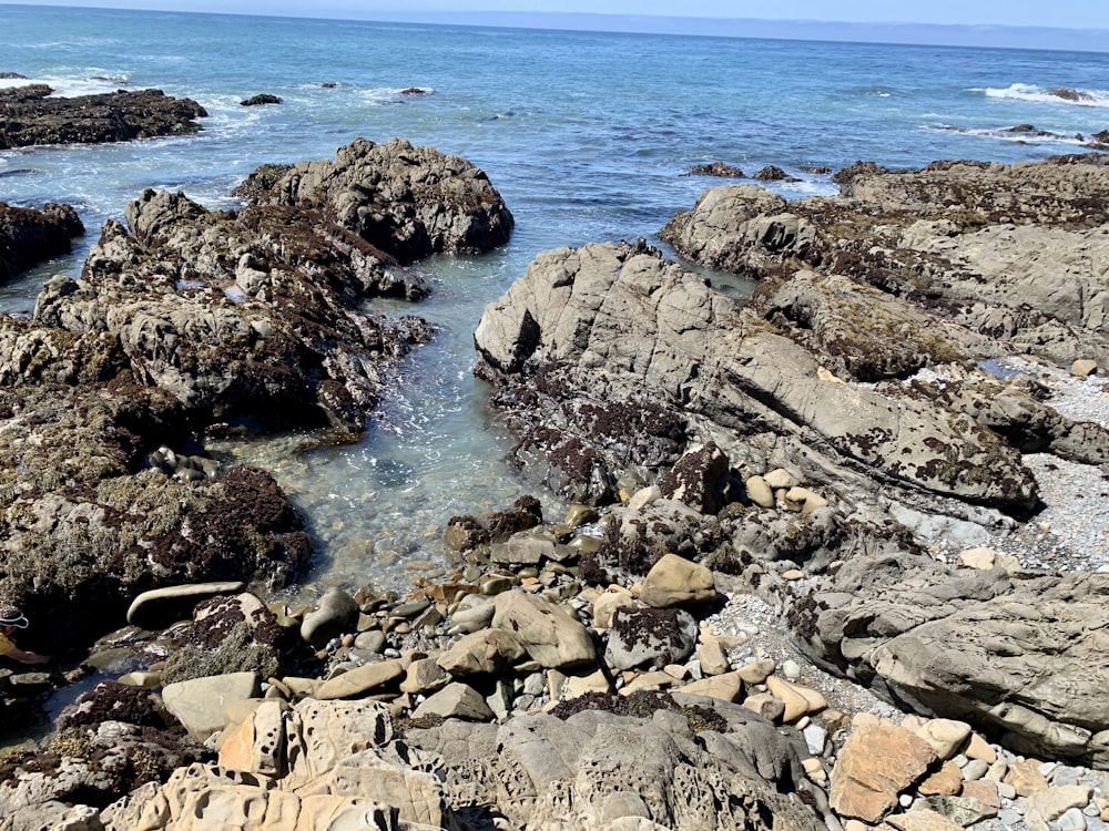 black rock formation beside sea
