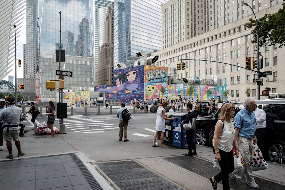 people walking at the streets with high-rise buildings