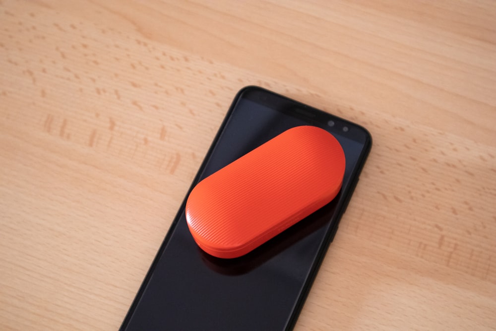 oval black case on black smartphone