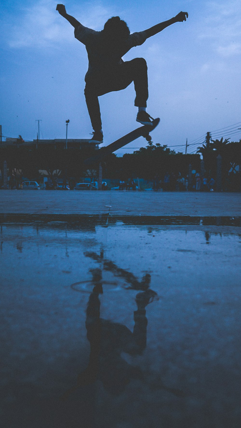 silhouette of person jumps with skateboard