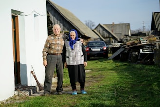 man and woman standing beside building and near cars