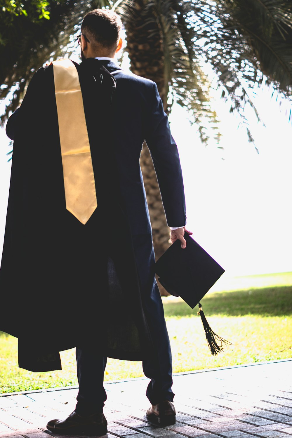 man holding academic regalia