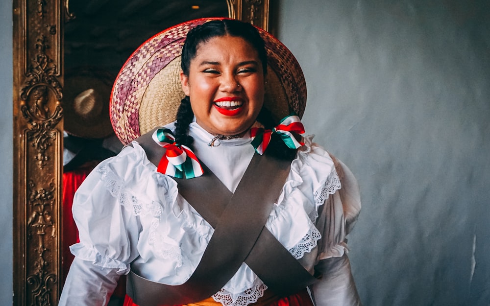 smiling woman wearing white long sleeved shirt