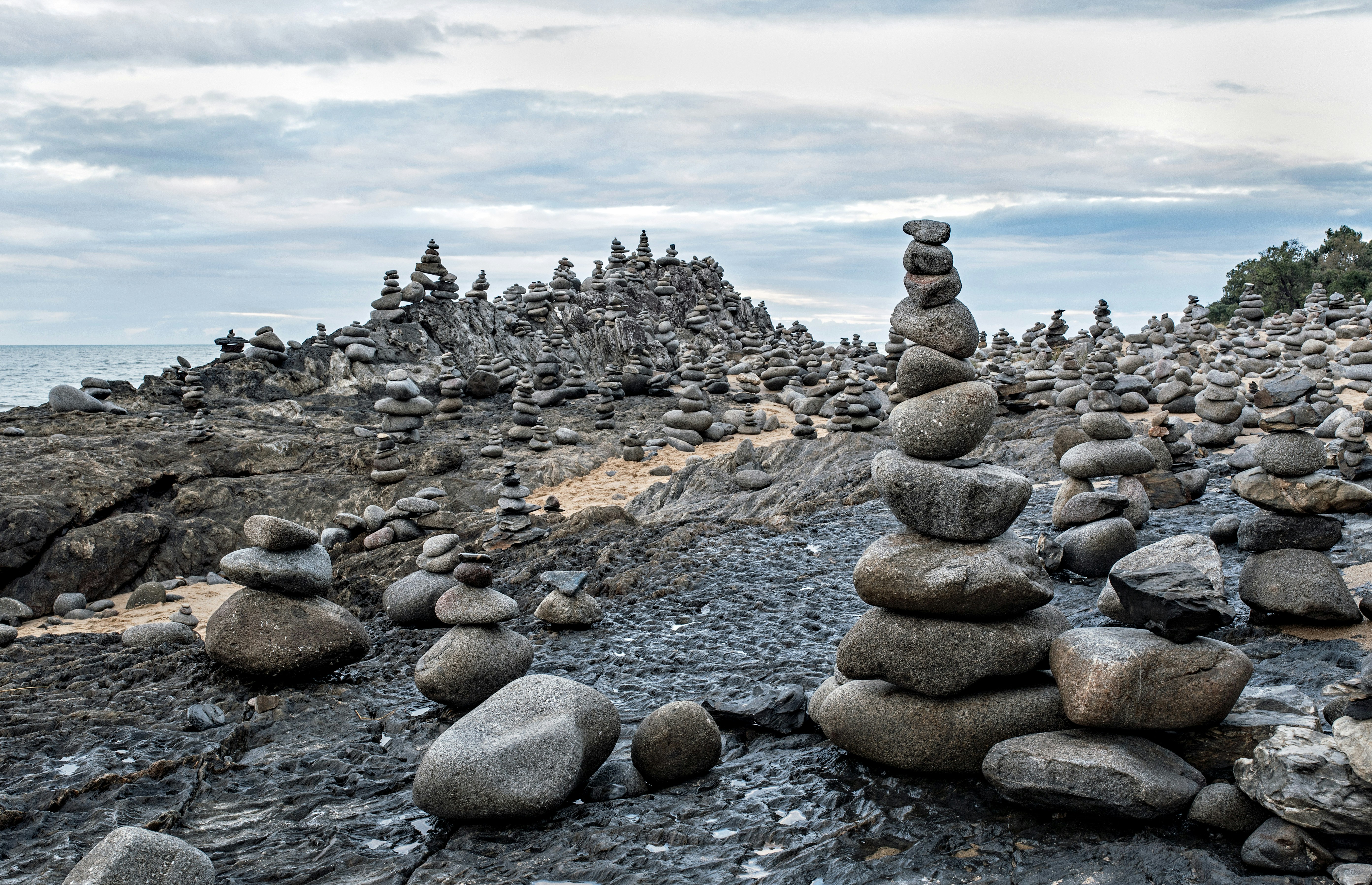 This spot has become very popular for people to balance stones on top of each other into towers, just for fun. The spot is between Ellis beach and Wangetti beach on the Captain Cook highway, North Queensland, Australia