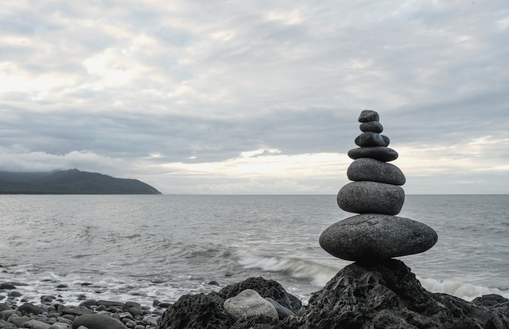 close-up photo of Cairn near seashore