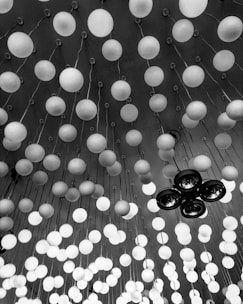 Monochrome shot of elegant modern party lighting hanging above an open space.