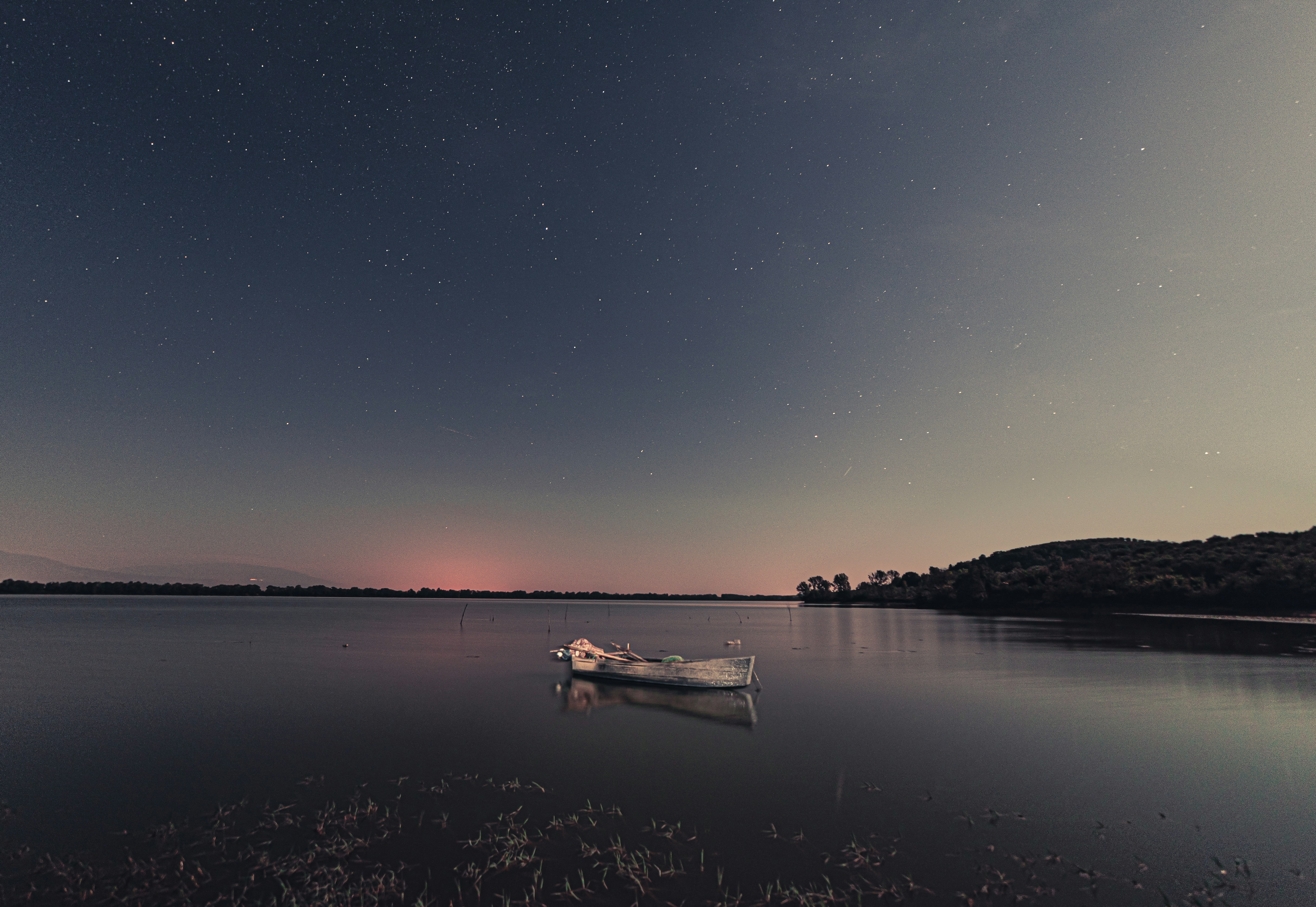 white boat on body of water during daytime