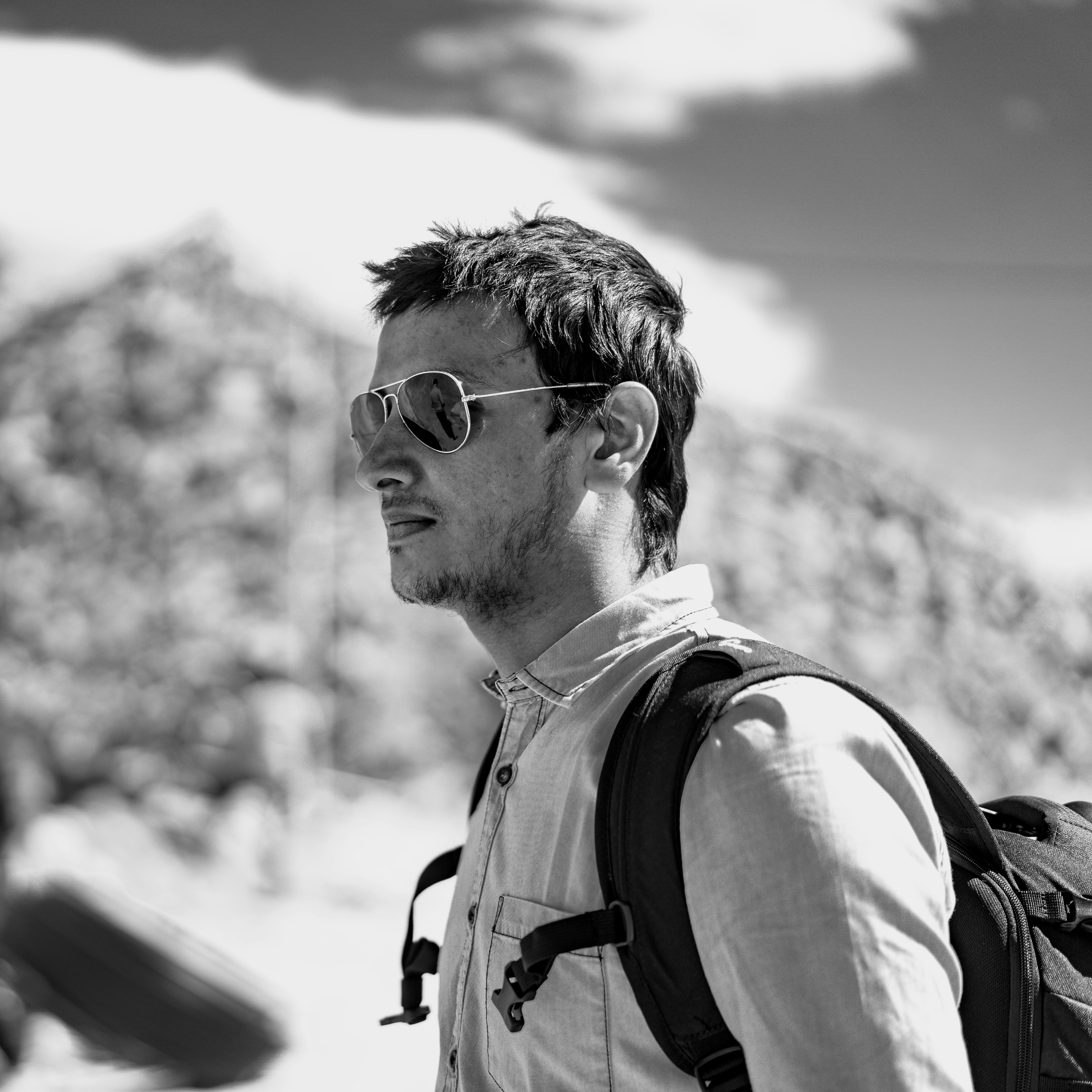 greyscale photo of man wearing sunglasses