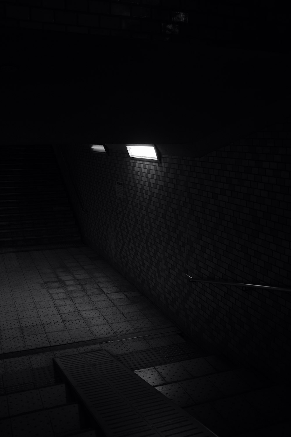 a dark room with some stairs and lights