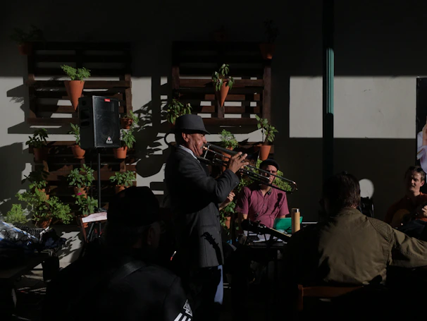 A lively workshop scene with trumpet players of various ages practicing together in a sunlit room.