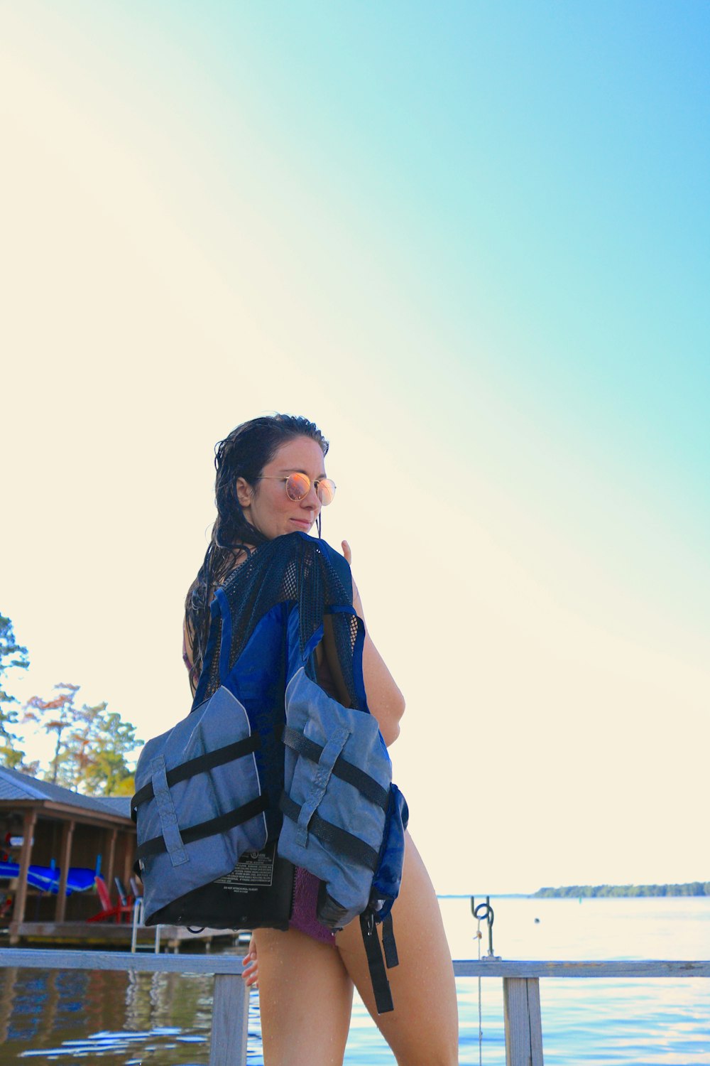 woman carrying blue and black vest