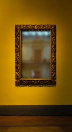 rectangular leaning mirror with brass-colored frame