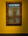 rectangular leaning mirror with brass-colored frame