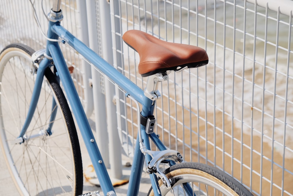 blue road bike beside handrail