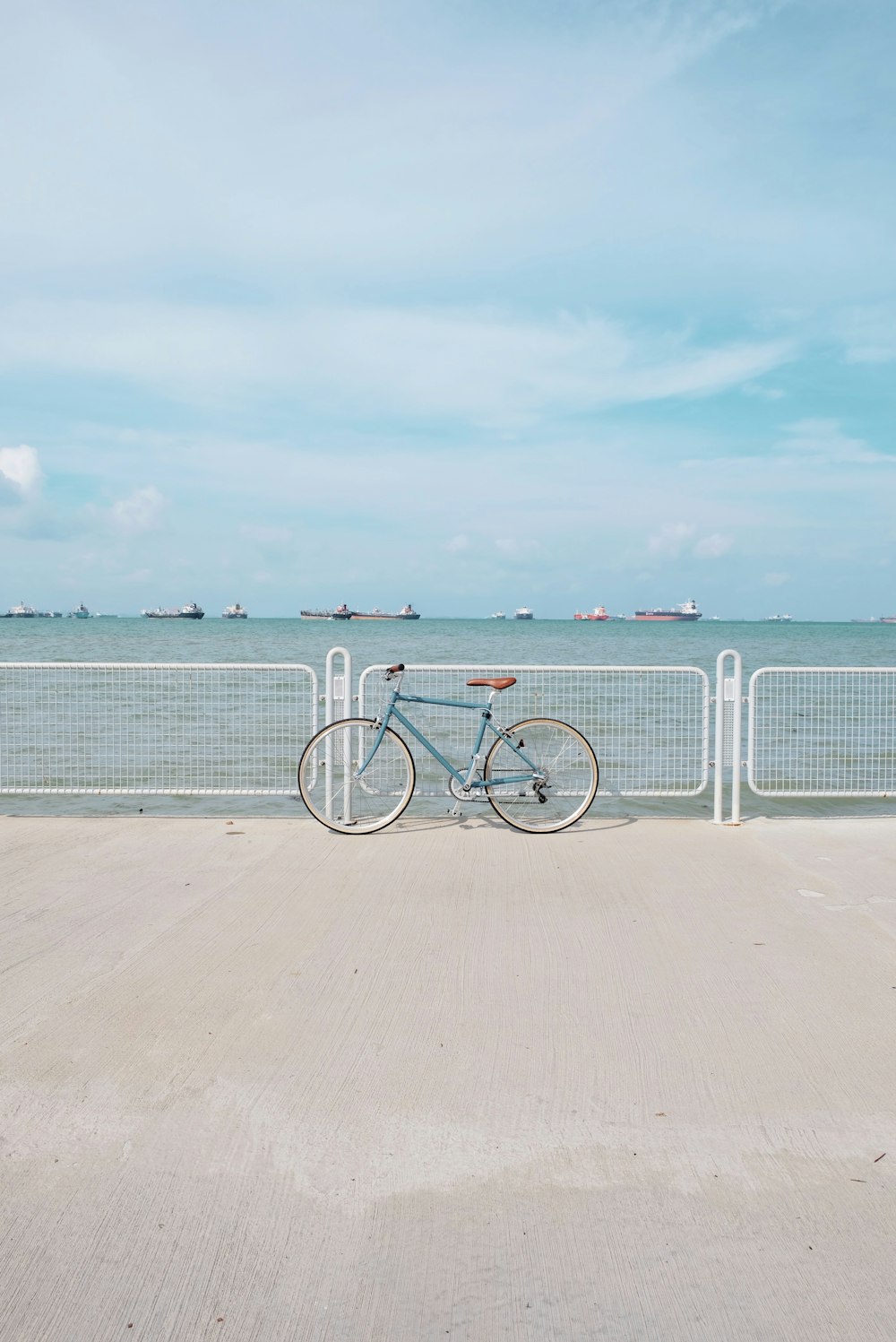 blue commuter retro bike leaning on dock railing