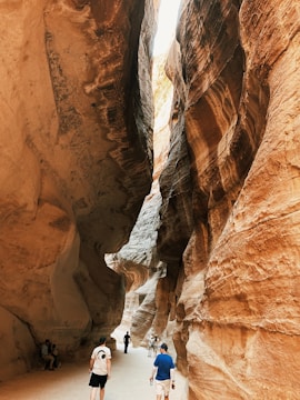 Tourists walking carefully through the winding paths of Antelope Canyon.
