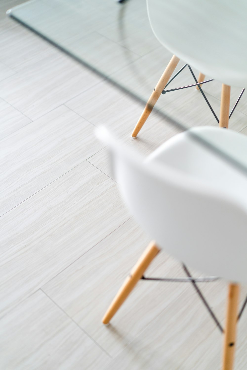 two white and brown wooden Eiffel chairs