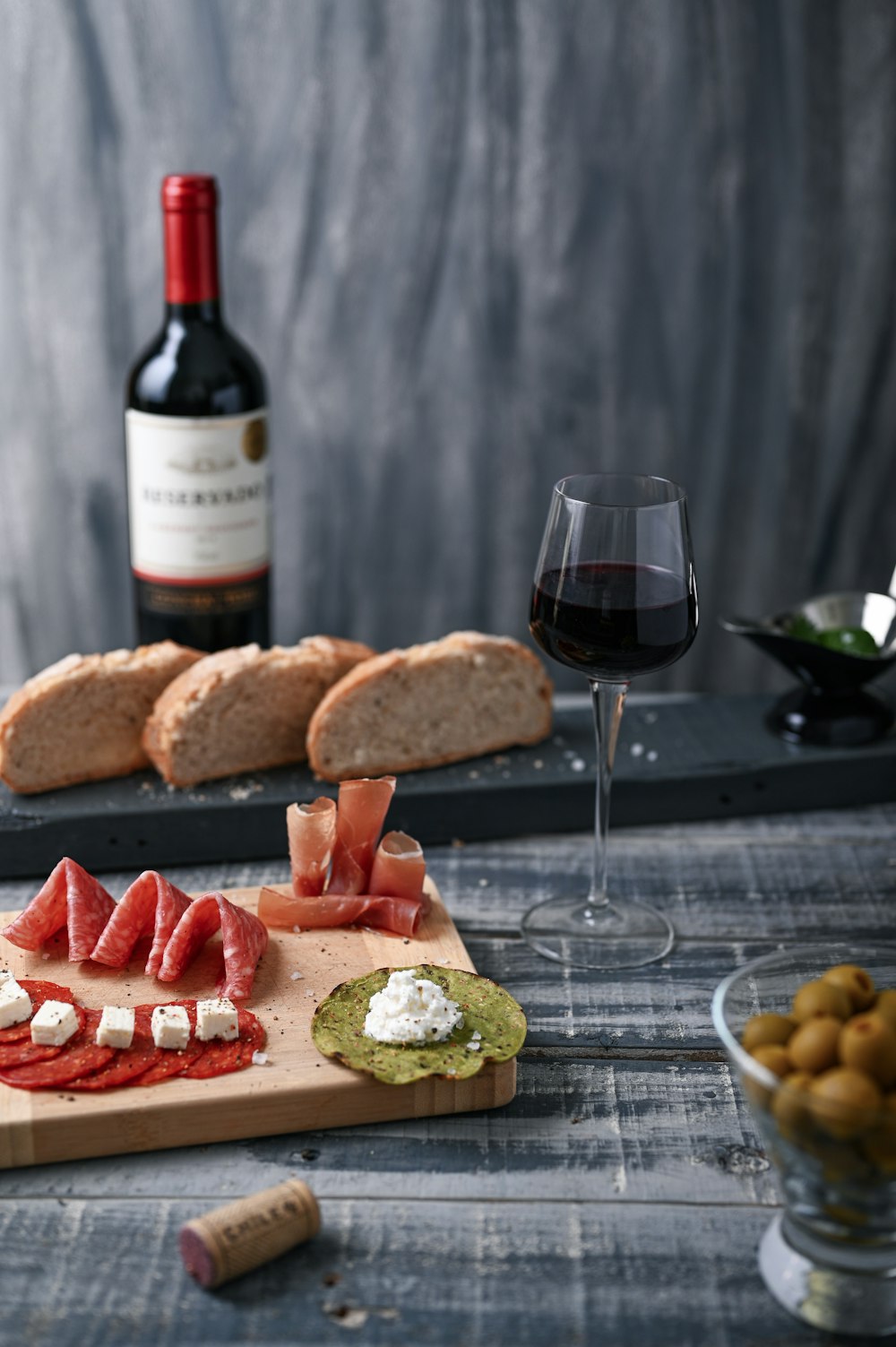 wine glass beside food on board