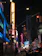 Outdoor LED sign glowing brightly at night in a bustling city street.